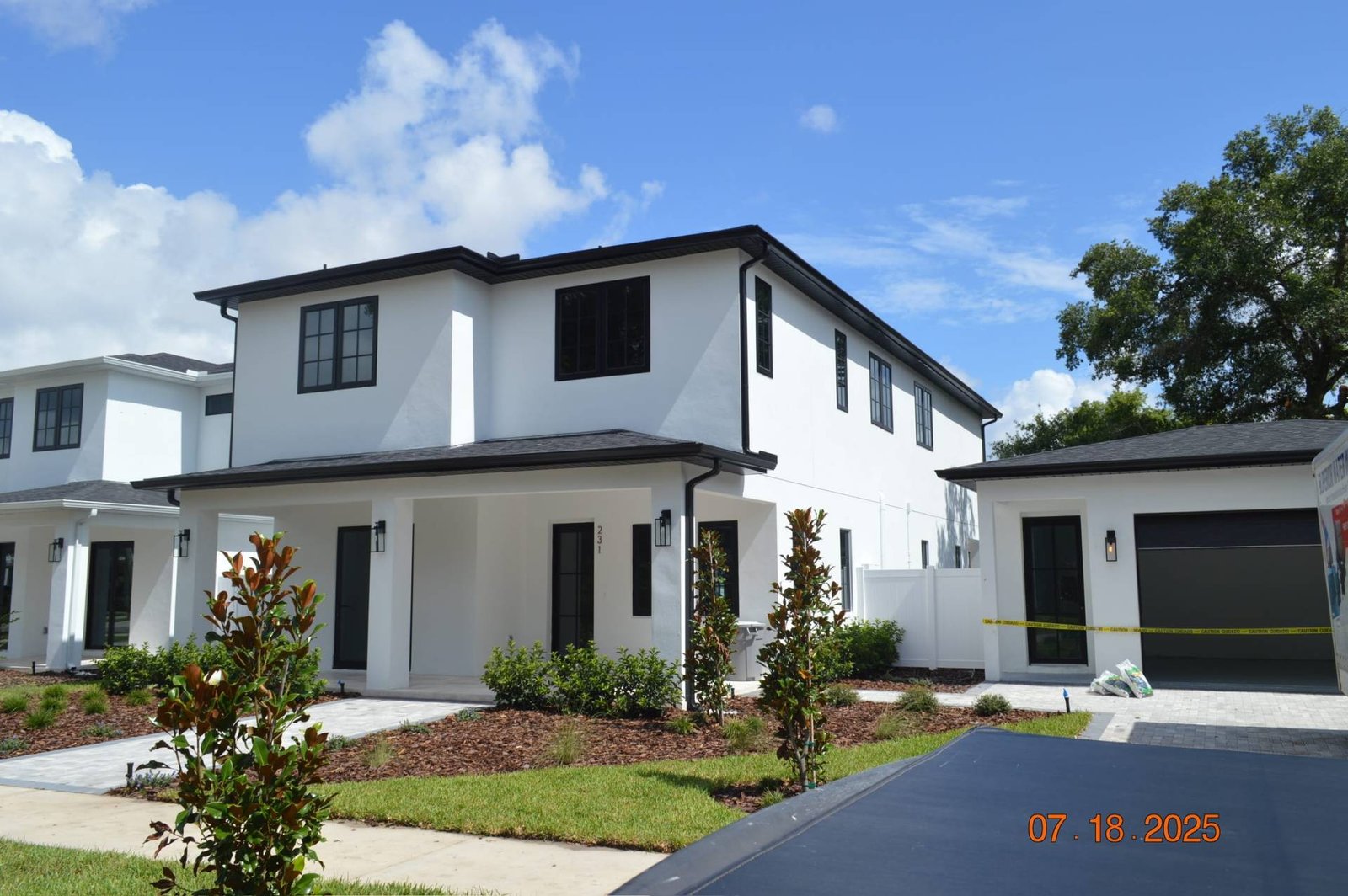 Modern white house with black trim, showcasing contemporary home design.